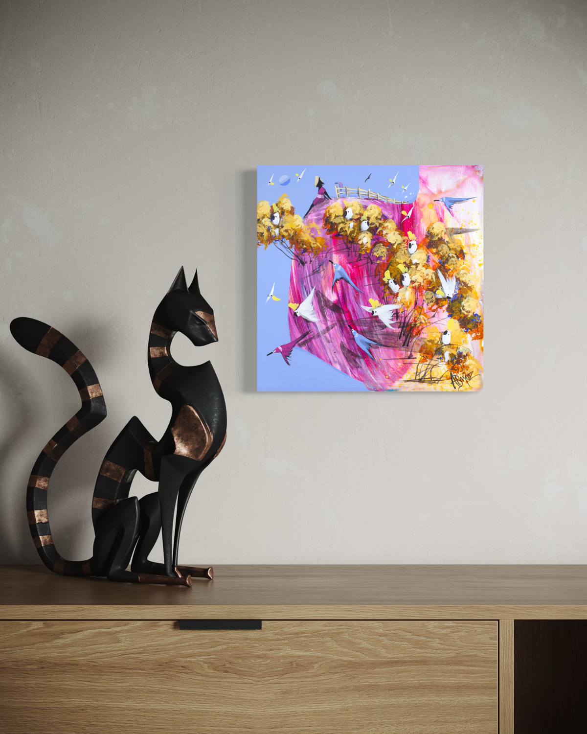 Open Hands by Adam Bogusz hanging unframed on a pale wall above a light oak sideboard beside a tall black cat sculpture, showing the scale of the painting in a room.