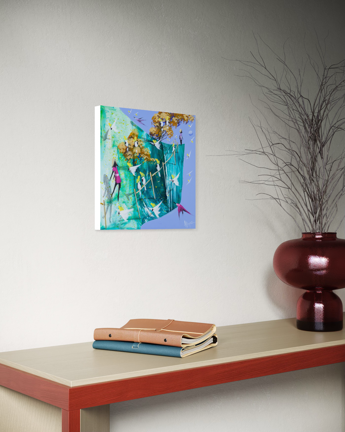 Side view of The Way Through by Adam Bogusz, 30 x 30 cm MDF board, showing the painted edge as it hangs on a grey wall above a red framed console table with a burgundy glass vase of bare branches and two leather bound notebooks.