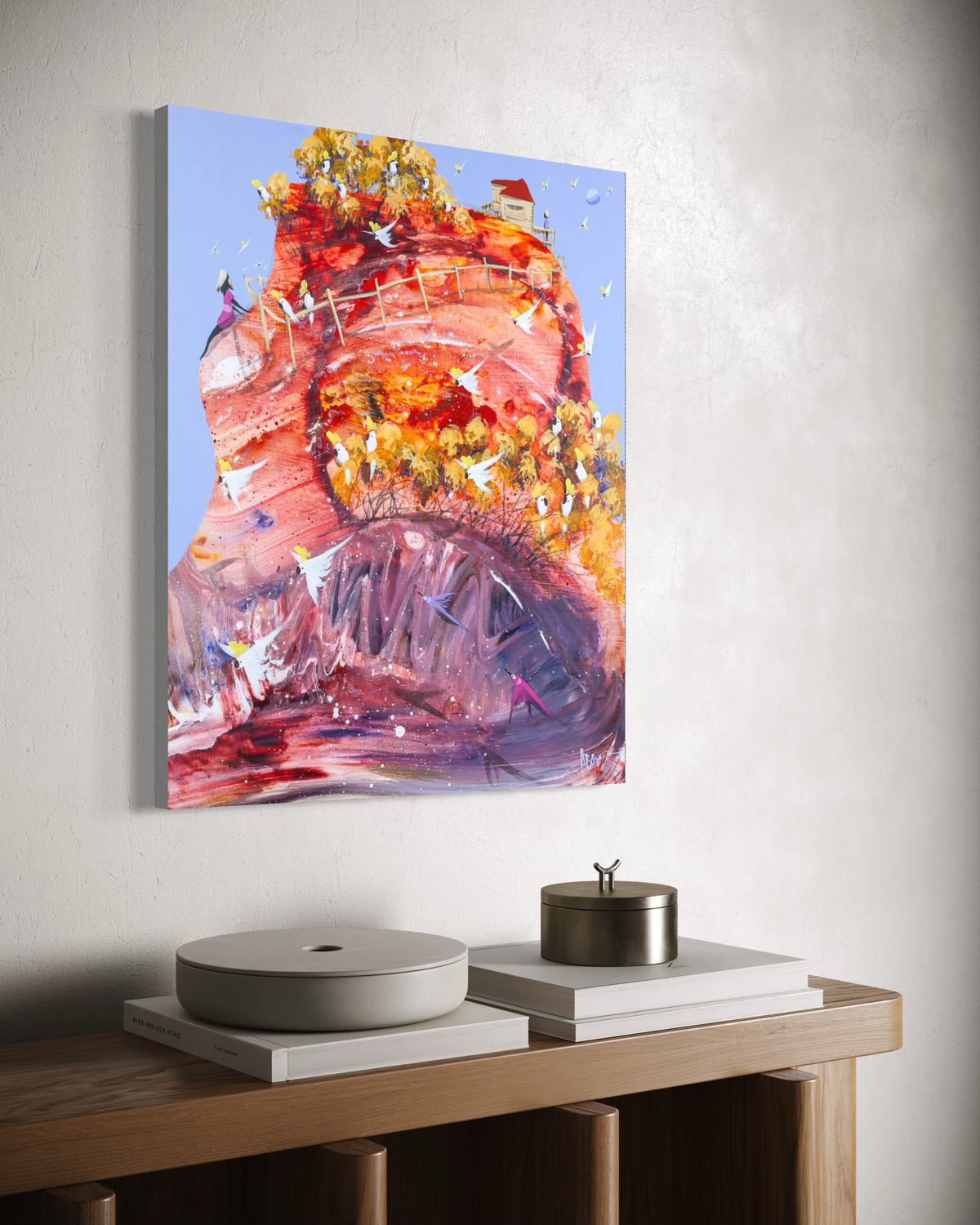 Side view of The Wiggly World by Adam Bogusz, 60 x 50 cm MDF board, showing the painted edge as it hangs on a white wall above an oak sideboard with white books, a pale ceramic dish and a metal canister.