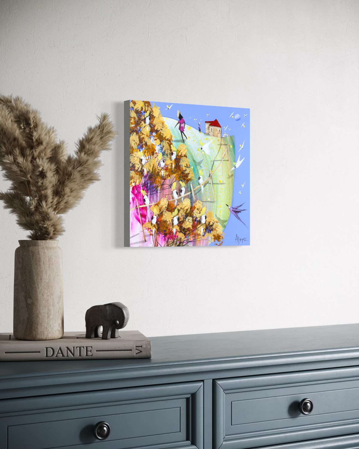 Side view of Already Home by Adam Bogusz, 30 x 30 cm MDF board, showing the painted edge as it hangs on a white wall above a blue grey dresser with dried pampas grass and a small elephant ornament.