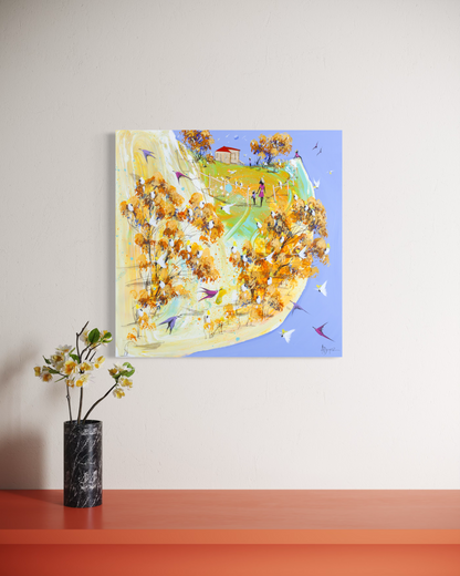 The Long Walk Home by Adam Bogusz shown at an angle on a pale wall above an orange ledge with white blossoms in a black marble vase, to indicate scale.