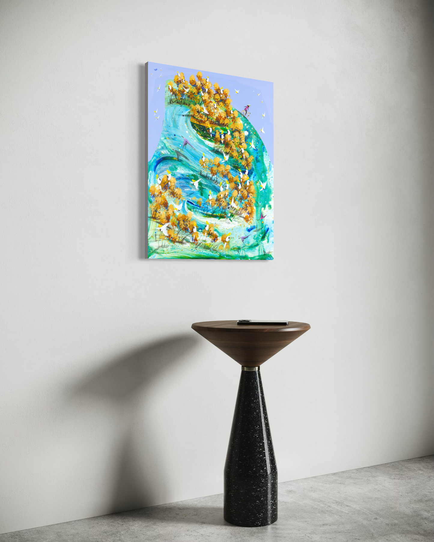 Freewheeling by Adam Bogusz hanging unframed on a pale wall above a walnut and terrazzo side table, seen at a slight angle so the depth of the painted board is visible.