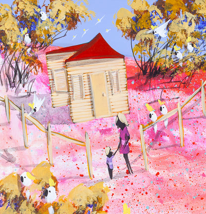 Detail of Still Holding On showing the little red-roofed house on the pink hill, with a mother and child holding hands and cockatoos gathered on the fence and in the golden trees.