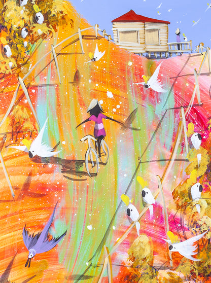 Detail of Lost and Found by Adam Bogusz, showing a girl in magenta riding a bicycle down a streak of orange and green with her arms spread wide, a red roofed cottage behind her and cockatoos flying past.