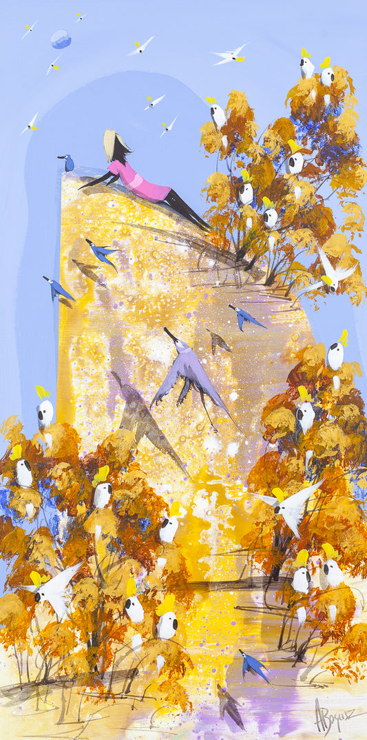 Nowhere to Be, original acrylic painting on board by Adam Bogusz. Tall golden landscape under a soft blue sky, with a woman in a pink dress lying back on a sunlit rock while sulphur crested cockatoos gather in ochre and rust trees and blue birds fly across the light.